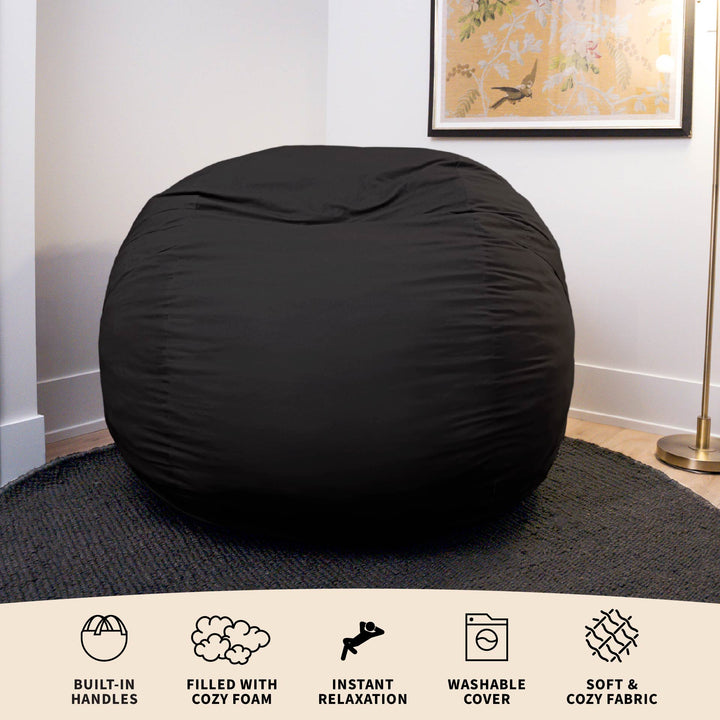 Black bean bag chair in a room with a framed picture on the wall. #color_black-brushed-denim