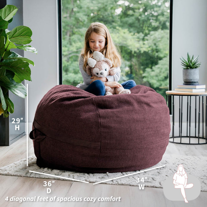 Child playing with stuffed animals on a large brown bean bag chair in a room with a window and plant. #color_merlot-cloudweave