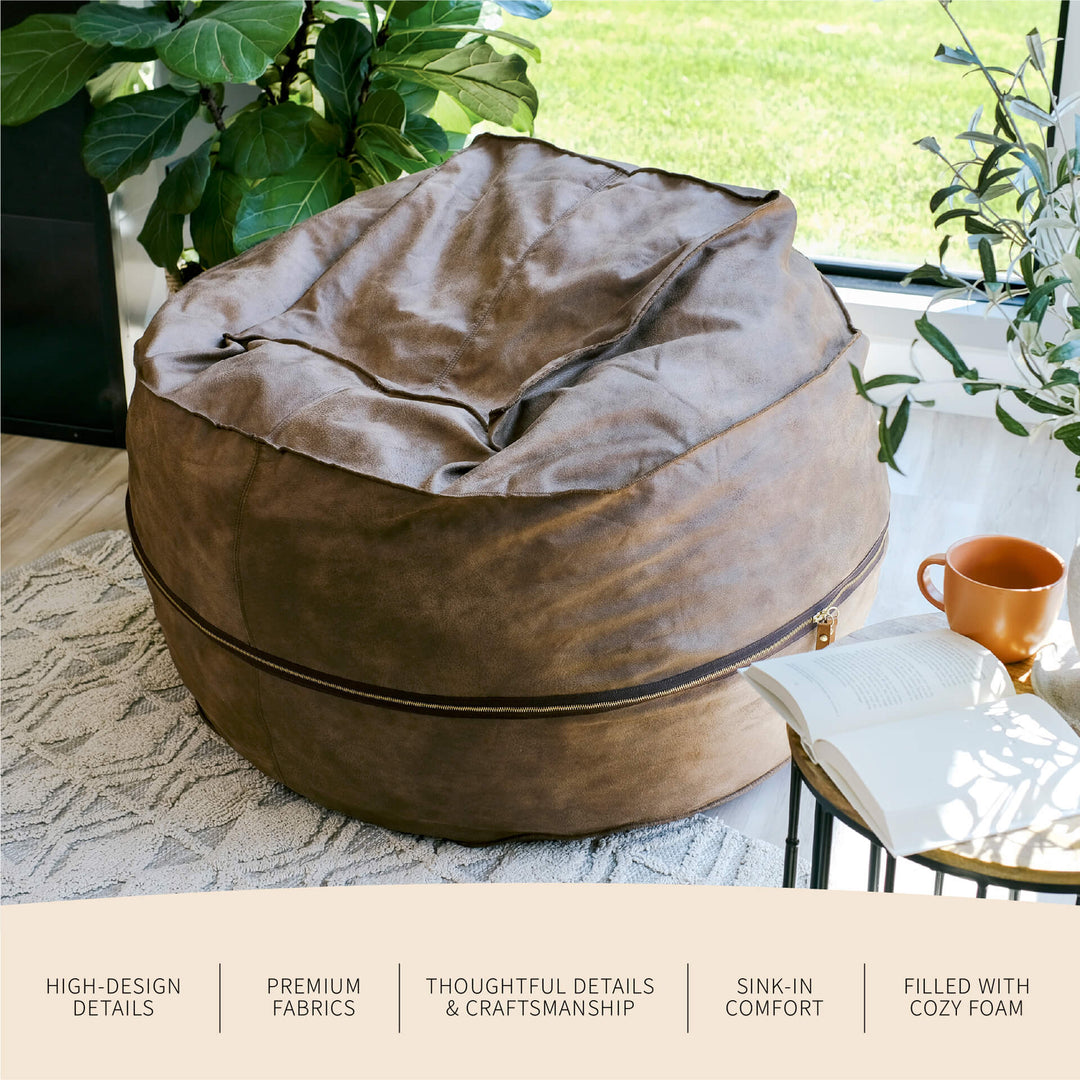 Brown bean bag chair in a living room setting with plants and a table. #color_coffee-soft-vegan-leather