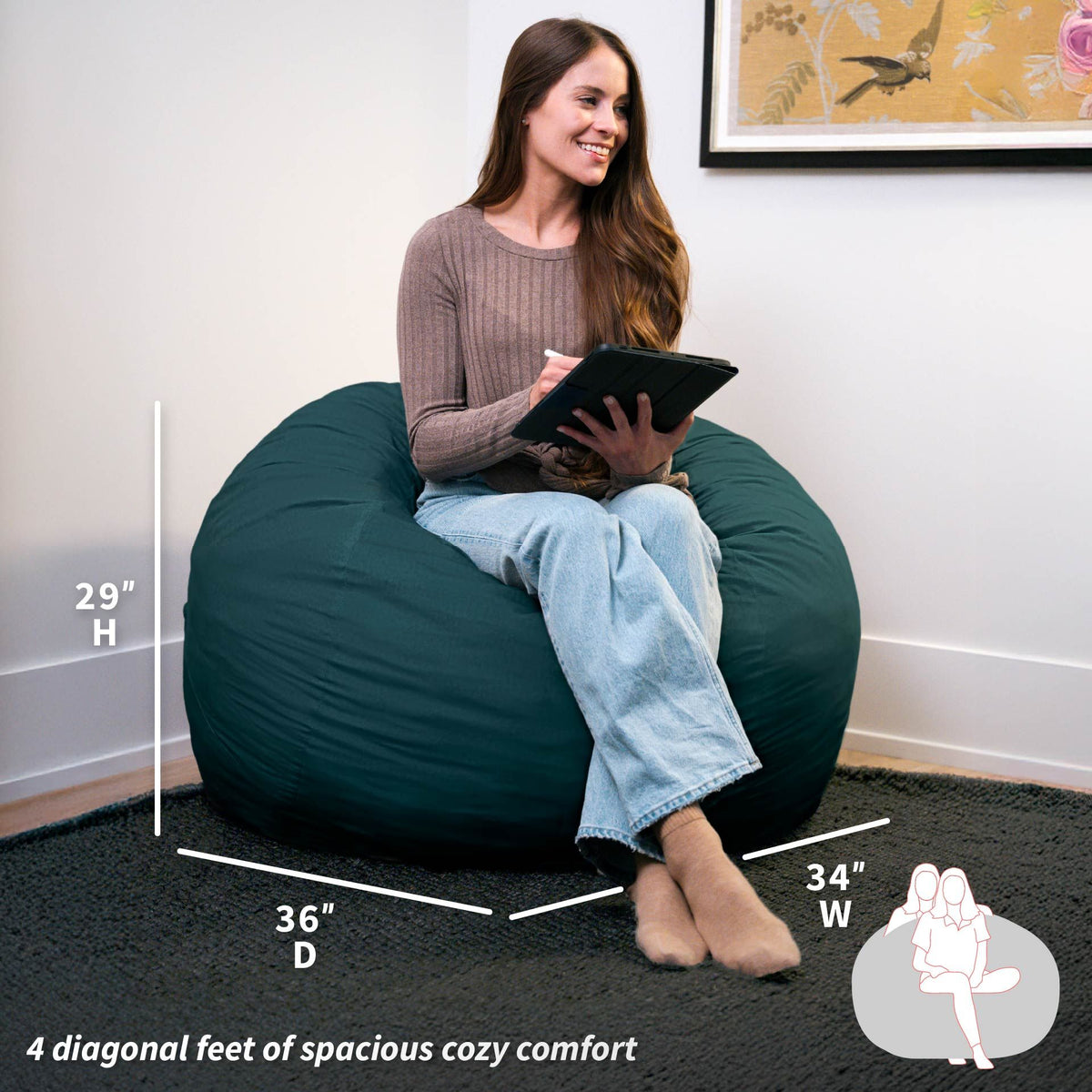 Woman sitting on a green bean bag chair holding a tablet, with measurements displayed. 