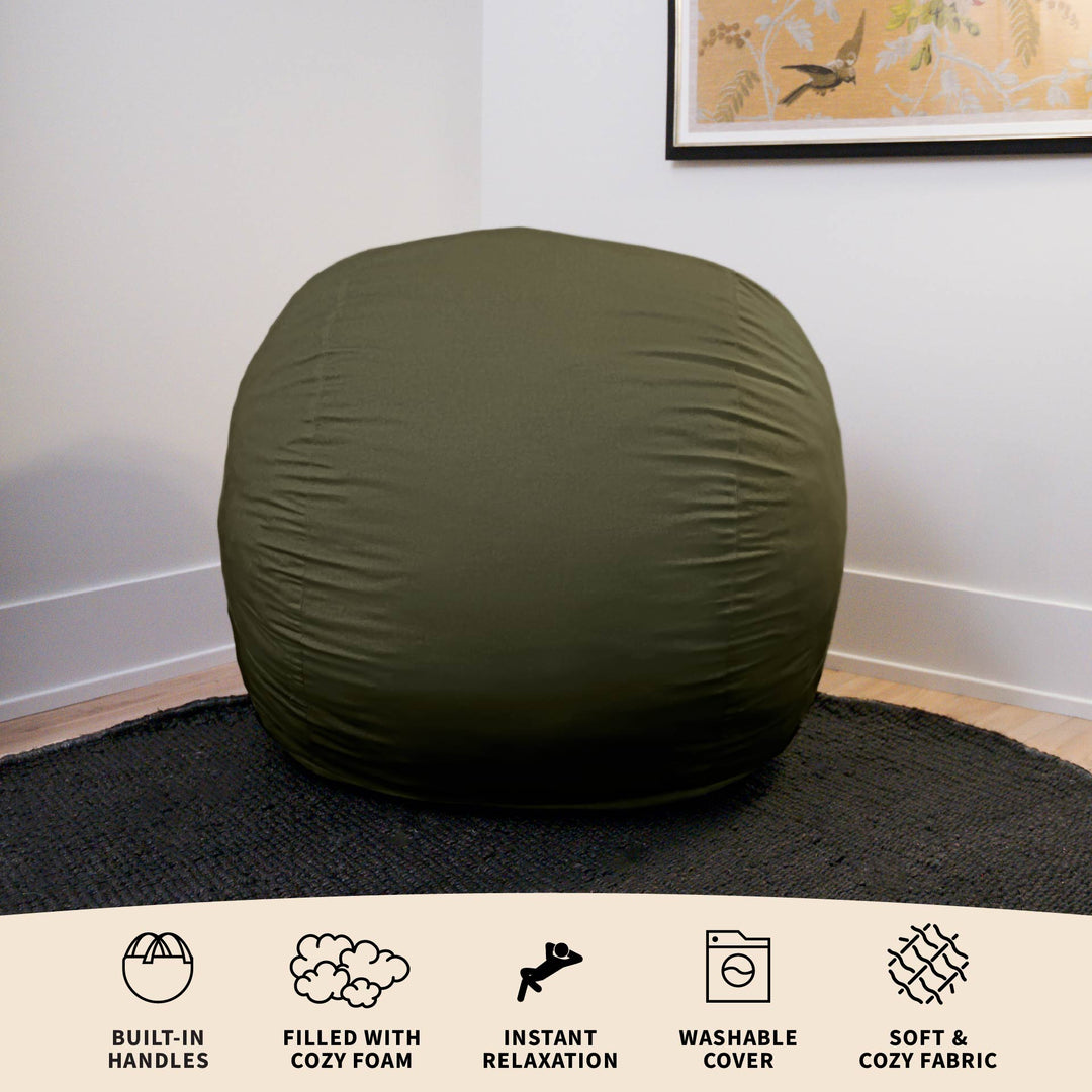 Green bean bag chair on a black rug with text describing features. #color_forest-green-velveteen