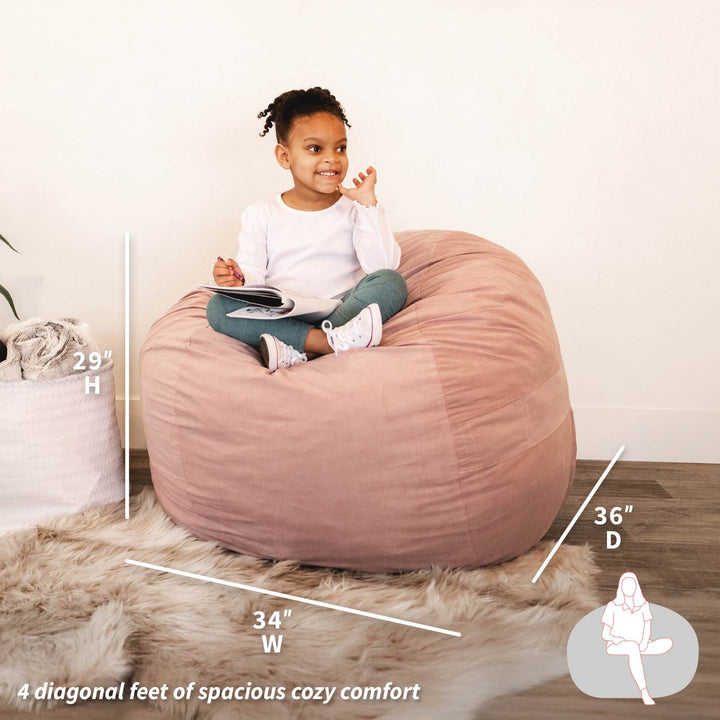 Child sitting on a pink bean bag chair with measurements displayed #color_desert-rose-brushed-denim