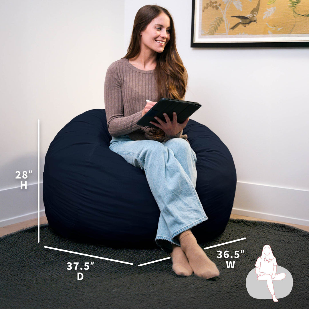 Woman sitting on a navy bean bag chair with measurements displayed #color_cobalt-brushed-denim