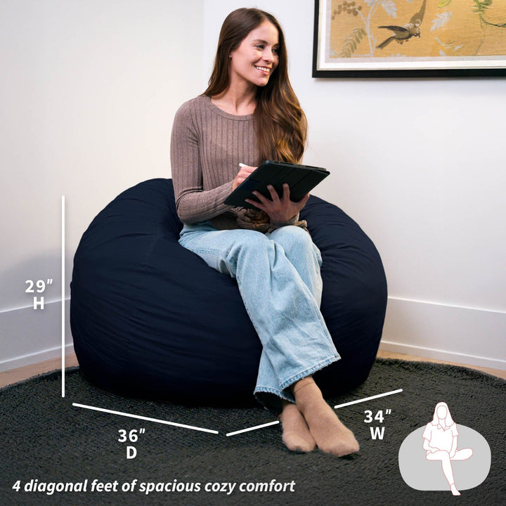 Woman sitting on a navy bean bag chair with measurements displayed #color_cobalt-brushed-denim