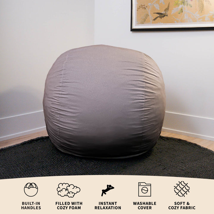Gray bean bag chair on a black rug with product features listed below. #color_fog-brushed-denim