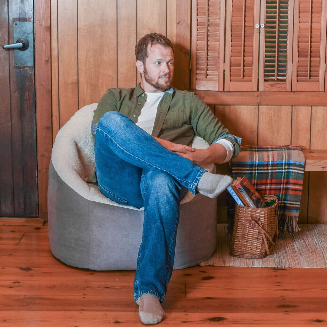 Cozy beanbag chair with man relaxing #color_graphite-sherpa-vegan-suede