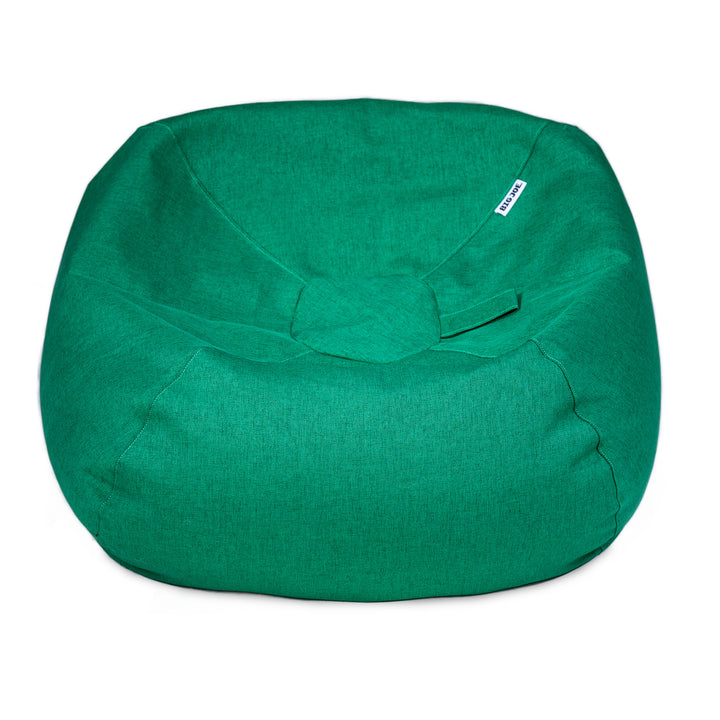 A green fabric bean bag chair with a small white brand tag on the upper right side, photographed against a solid white background. 