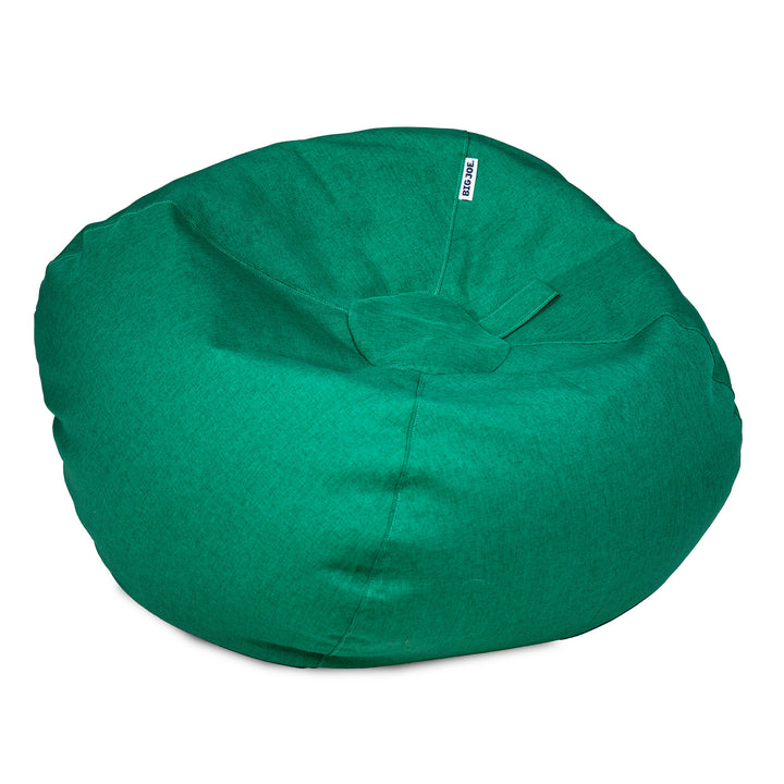 A round green bean bag chair with a small white brand tag reading &