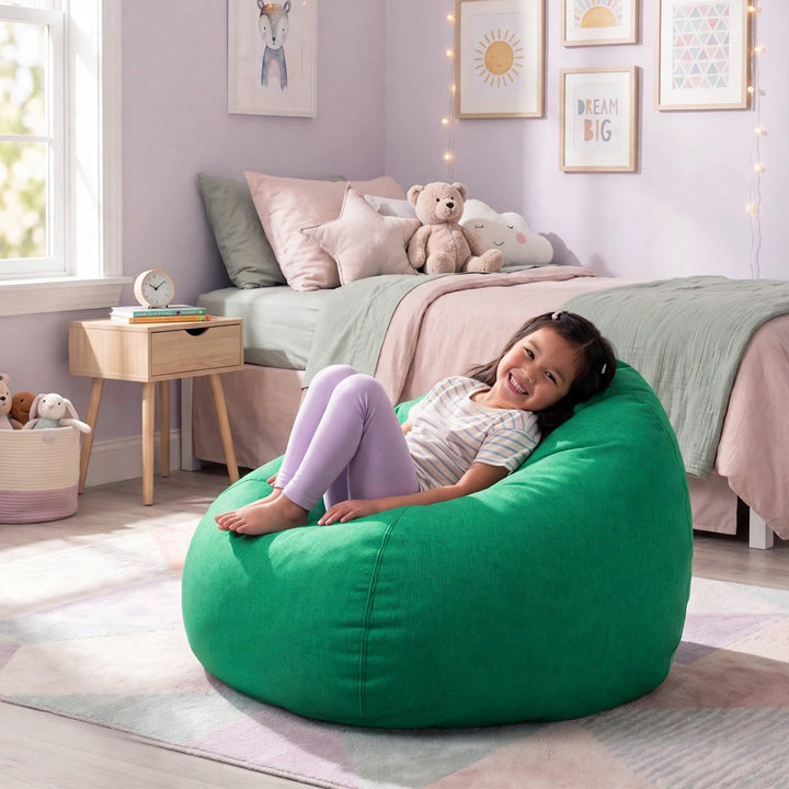 A young girl smiling while reclining on a large, round green bean bag chair in a beautifully decorated children&