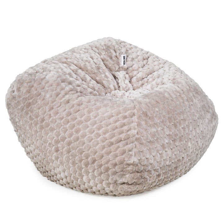 A round, plush bean bag chair in a textured boucle fabric, shown on a clean white background. A small white tag with the brand name &