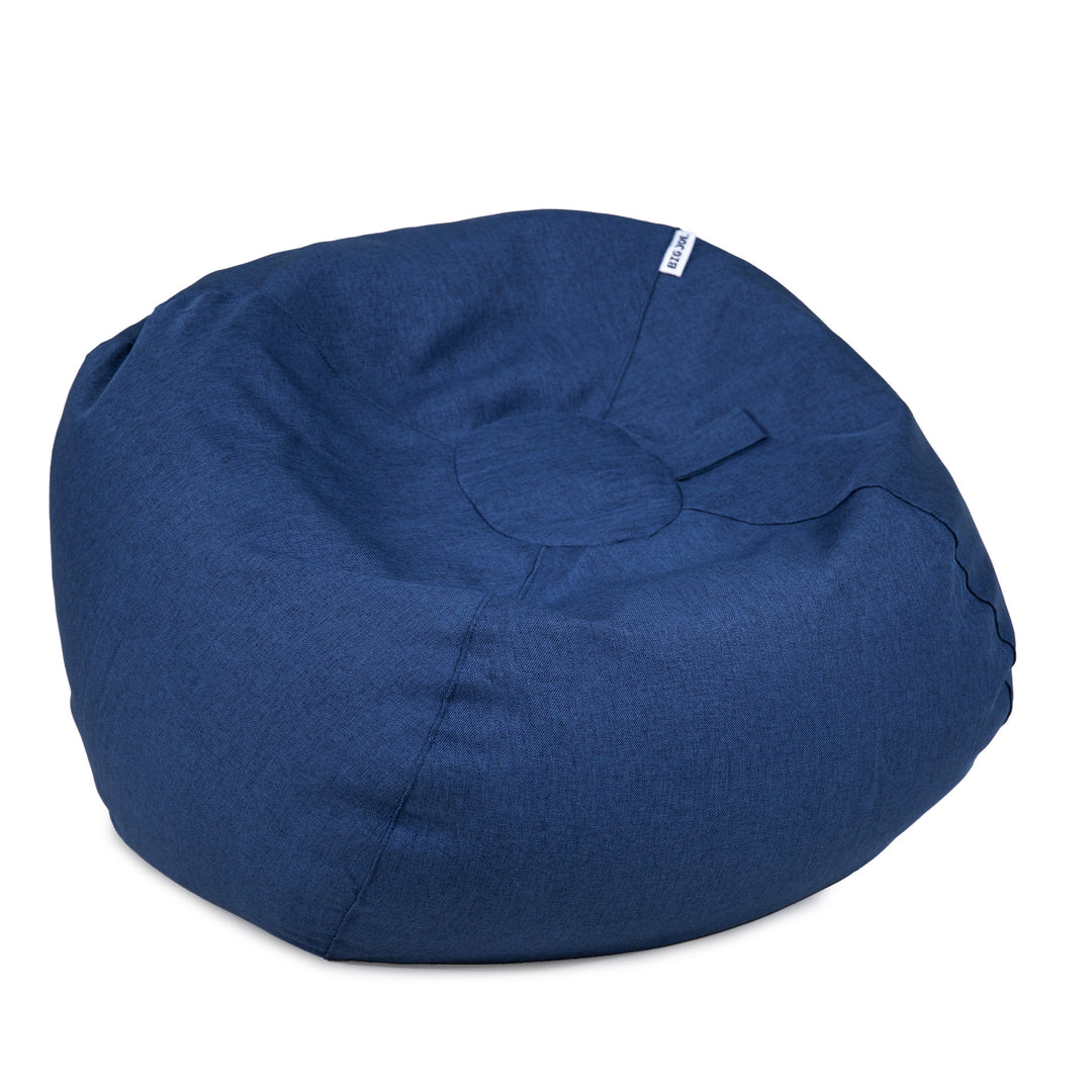 A round, deep blue fabric bean bag chair with a small white brand tag on the upper right side, photographed against a solid white background. 