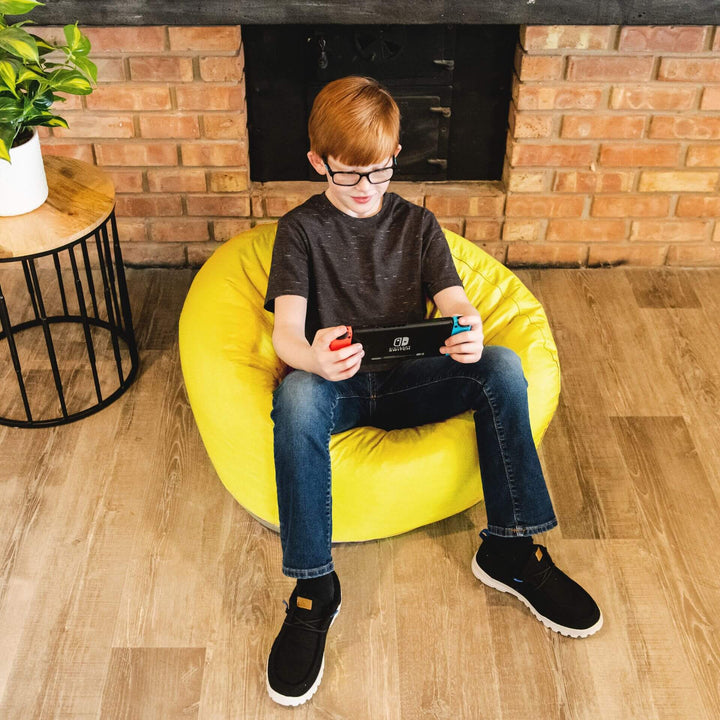 Boy playing games on yellow bean bag chair for kids #color_buttercup-smartmax