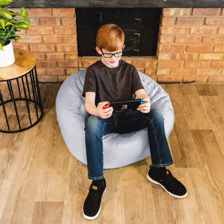 Boy playing video game in bean bag chair #color_gray-smartmax