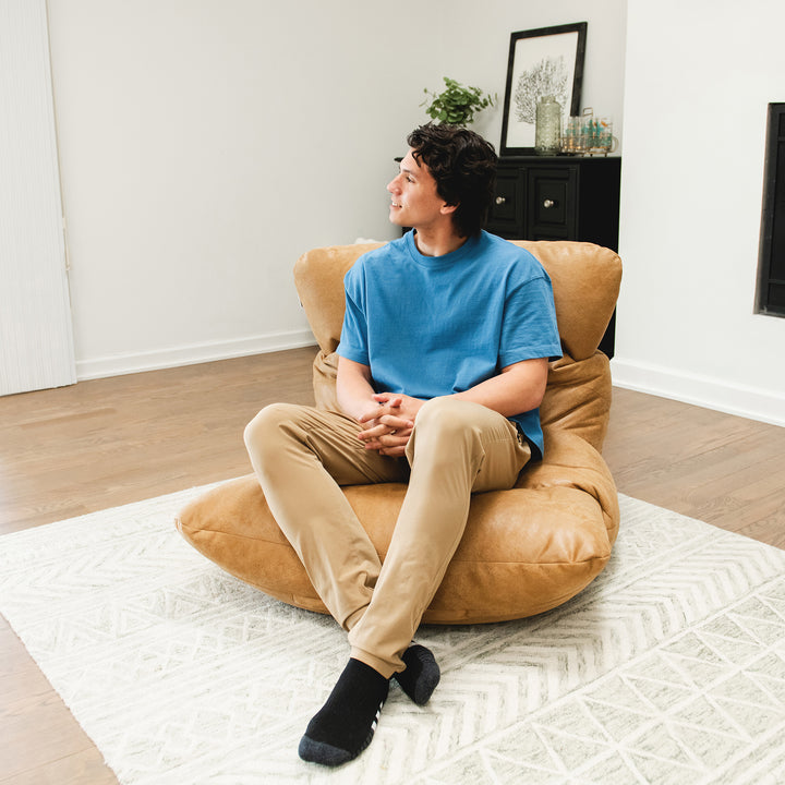 Man relaxing on the Roma Bean Bag Chair for adults #color_rustic-tan