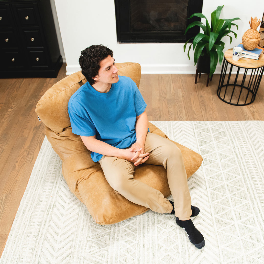 Lounging on the Roma Bean Bag Chair for adults #color_rustic-tan