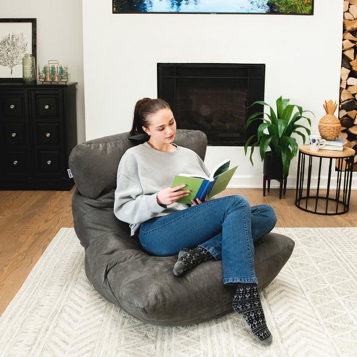 Woman reading on the Roma Bean Bag Chair in Shadow Graphite Vintage Suede #color_shadow-graphite