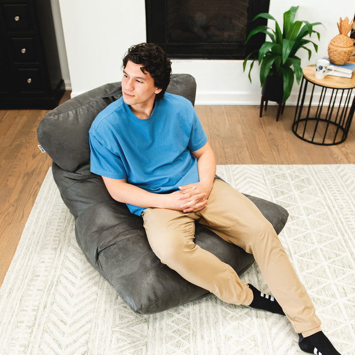 Man relaxing on the Roma Bean Bag Chair in Shadow Graphitel Vintage Suede #color_shadow-graphite