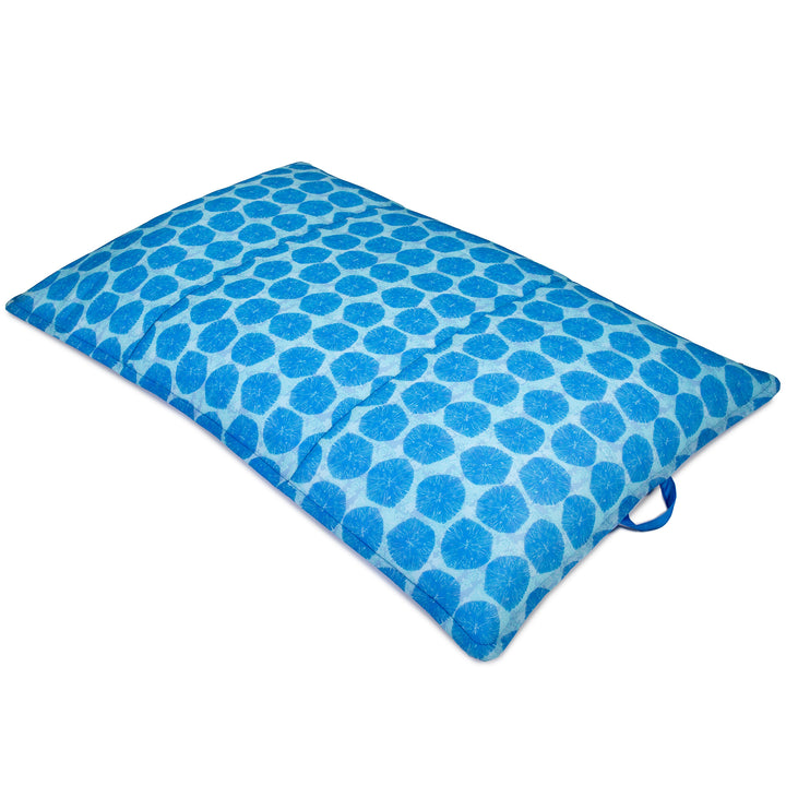 Blue patterned pool float on a white background #color_coral-bloom