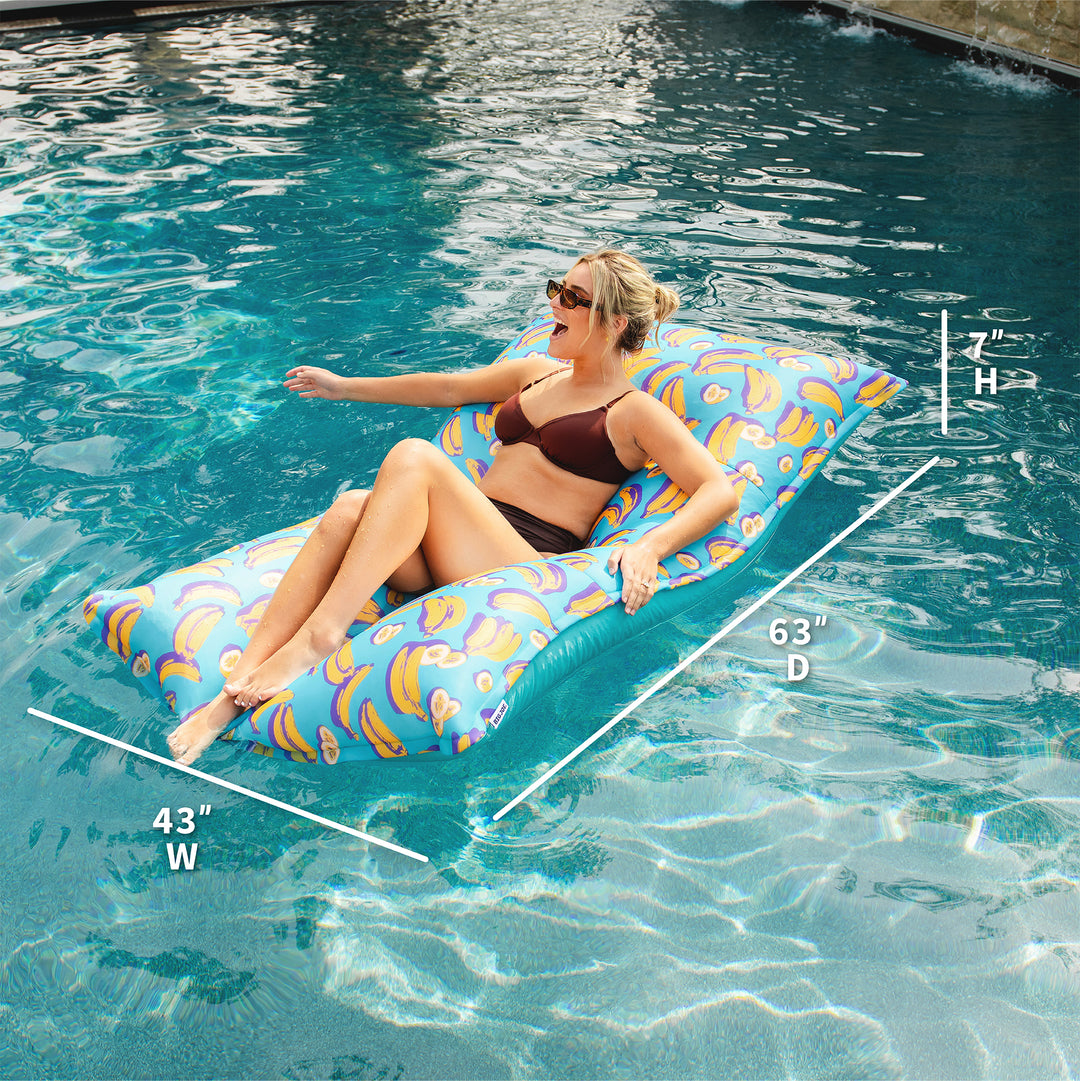 Woman lounging on a colorful pool float with measurements displayed. #color_banana-pop
