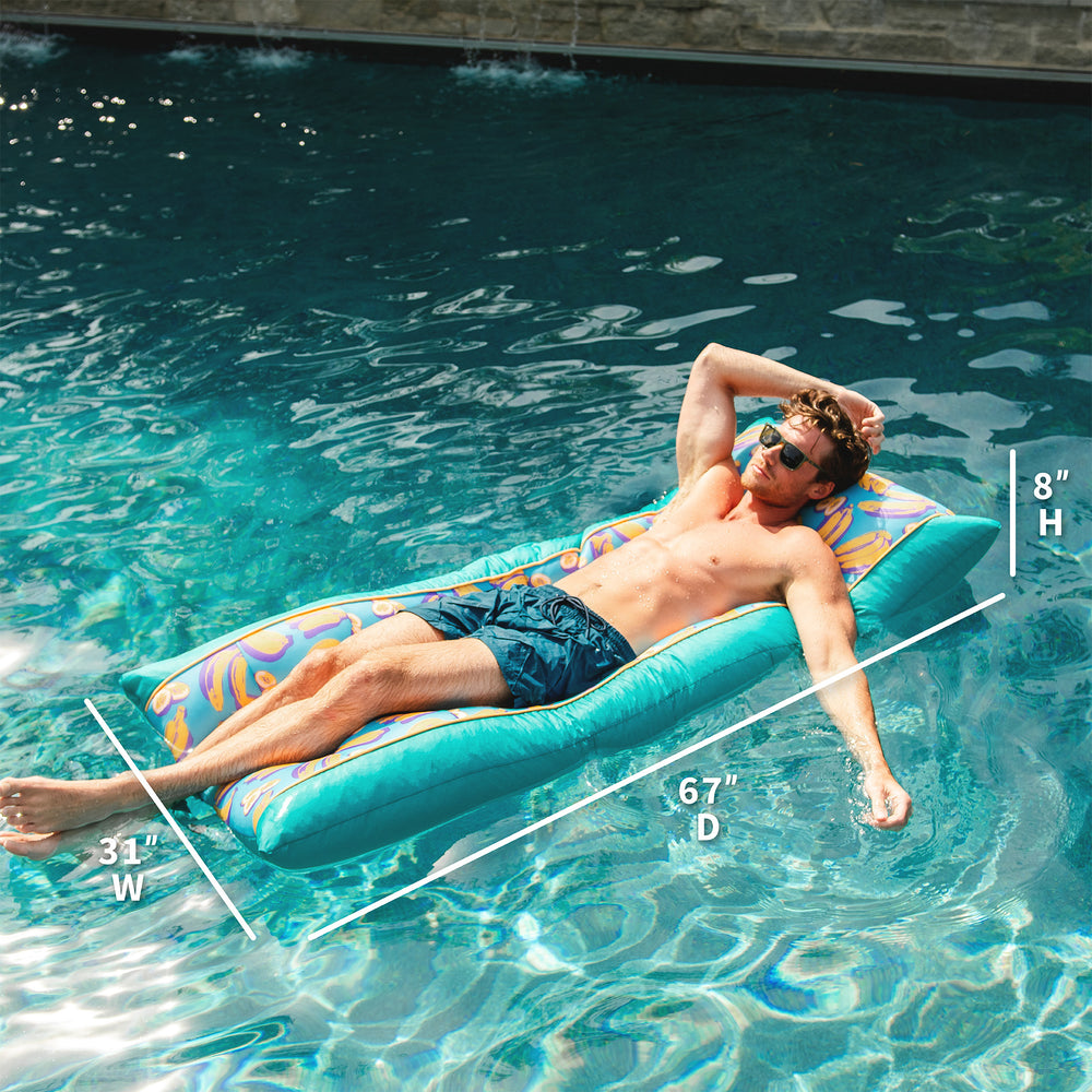 Man lounging on a colorful pool float in a pool with measurements  displayed. #color_banana-pop
