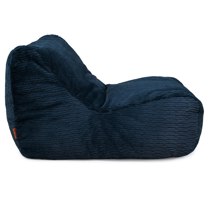 A dark navy blue textured bean bag chair with a wavy ribbed fabric, shown from a three-quarters angle on a solid white background. 