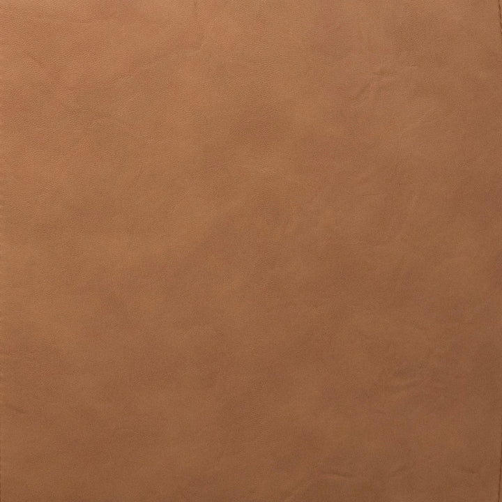 A close-up of a smooth, warm tan-brown textured material surface, resembling leather or faux leather. 
