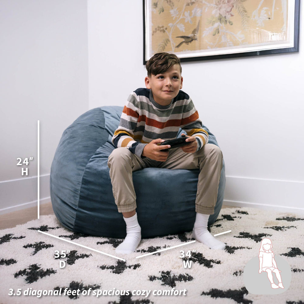 Child sitting on a blue bean bag chair with measurements displayed #color_slate-blue-plush