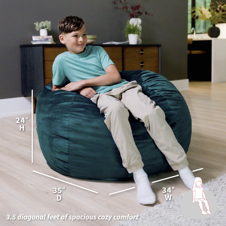 Child sitting on a teal bean bag chair with dimensions displayed #color_mediterranean-plush