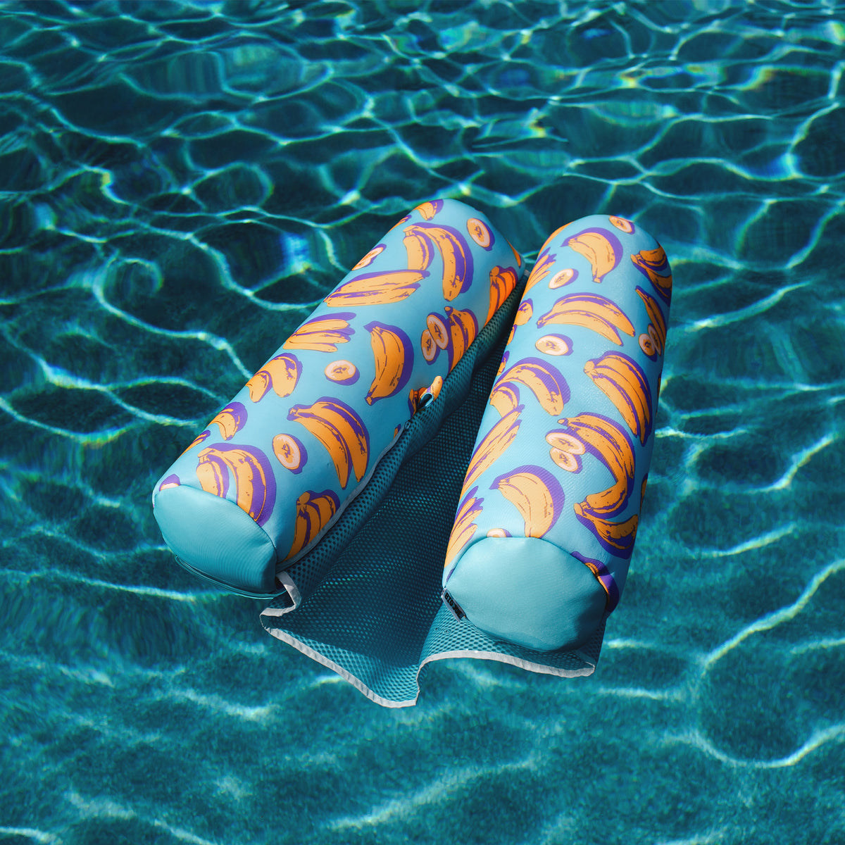 Colorful swim floatation device with floral pattern on a pool floor 