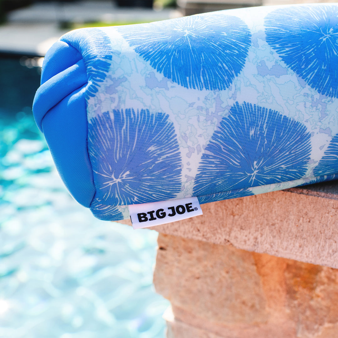 Blue pool float with 'BIG JOE' label by a pool #color_coral-bloom