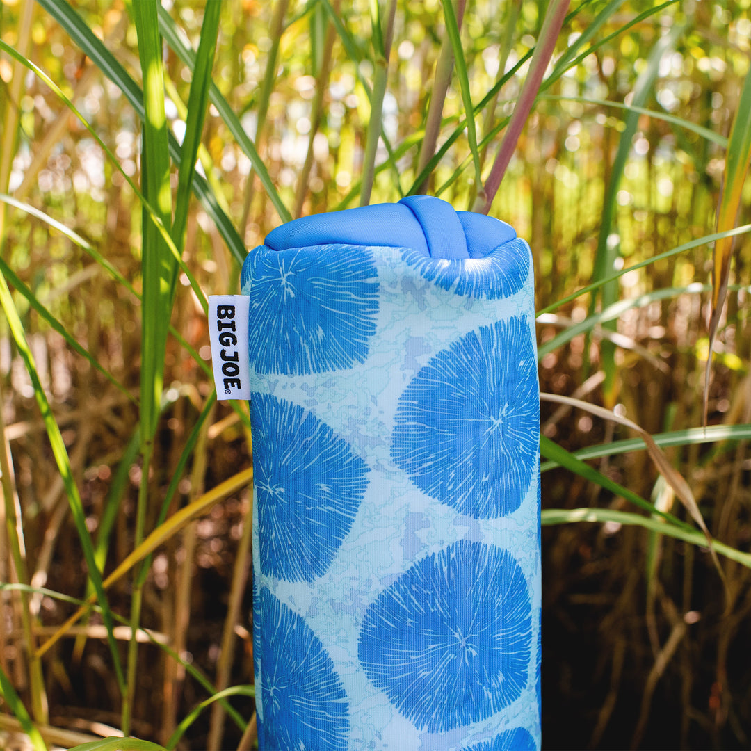 Blue cylindrical pool noodle with circular pattern and 'BIG JOE' tag against a natural background #color_coral-bloom