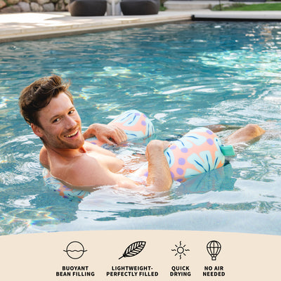 Man in a pool with a colorful product, featuring text about product features. 