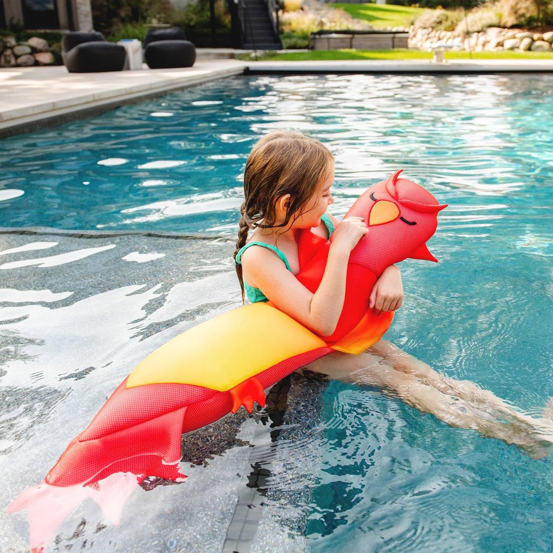 Child playing with a red and yellow bird pool noodle toy in a pool #style_phoenix