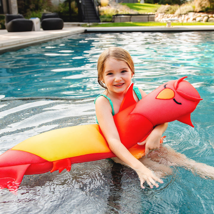 Child on a colorful phoenix bean pool float in a pool #style_phoenix