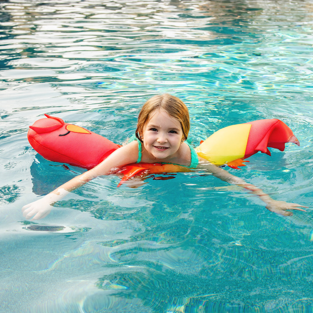 Child floating on a red and yellow pool toy in a pool #style_phoenix