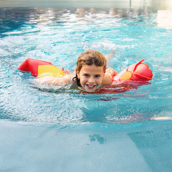 Child swimming in a pool with colorful pool float #style_phoenix