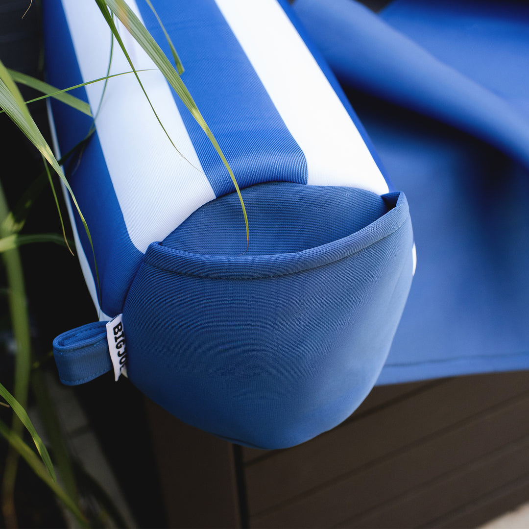 Blue and white noodle sling with a plant in the foreground #color_americana-nautical-stripe