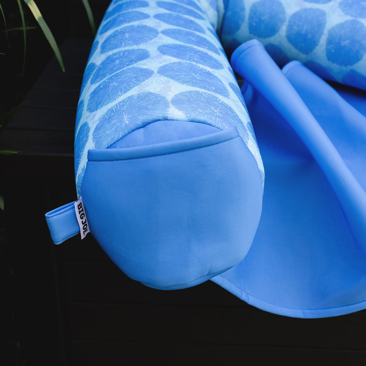 Blue pool float with a patterned top on a dark background #color_coral-bloom