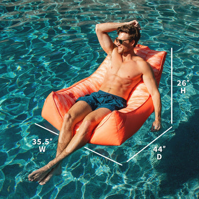 Man lounging on an pool chair in a pool with dimensions  
