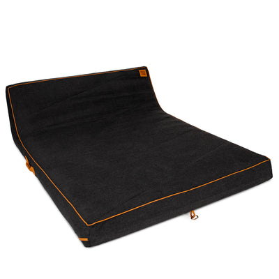 Black pool float with orange stitching on a white background 