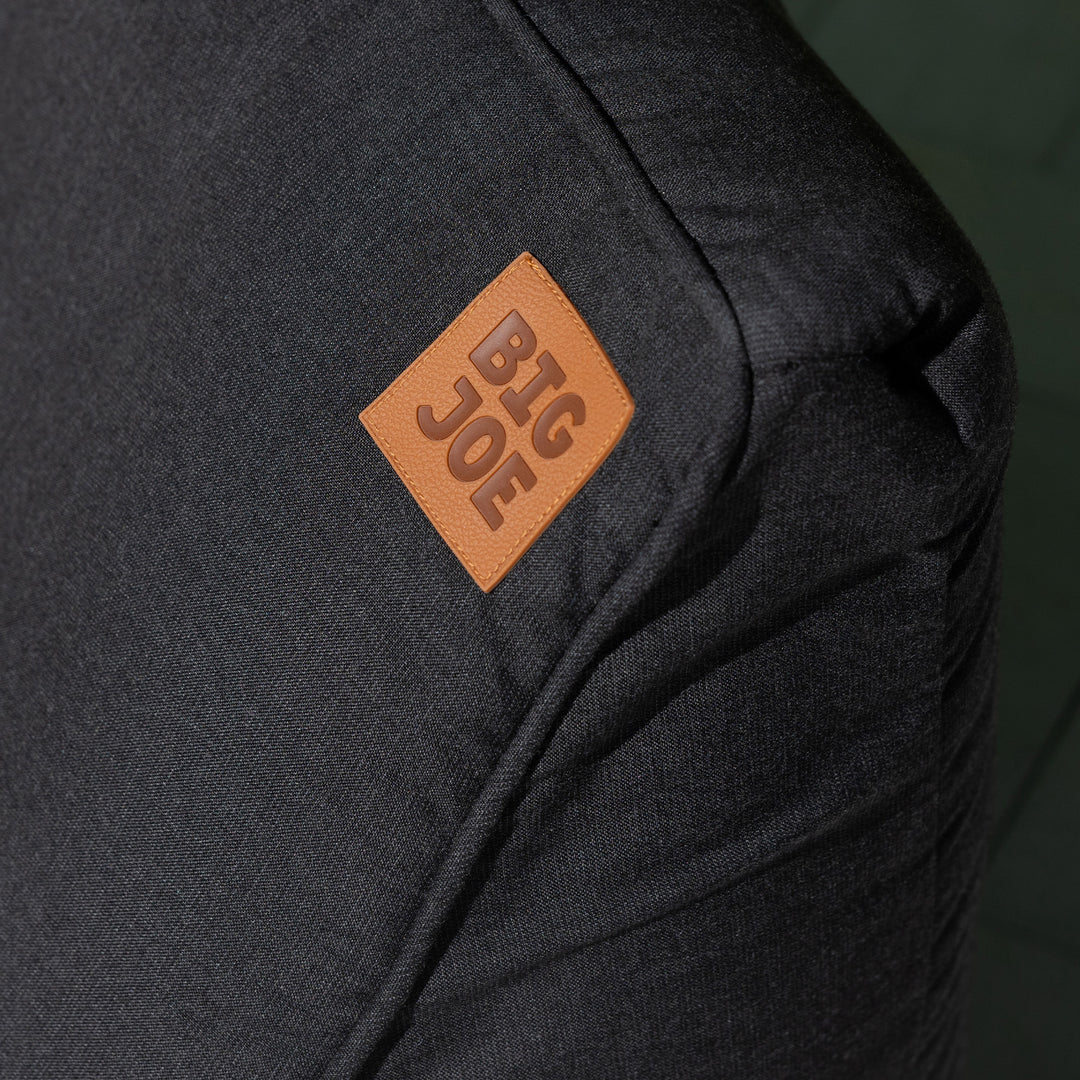 Black pool float with a brown leather patch displaying 'BIG JOE' on a dark background #color_twilight-sunbrella-fabric