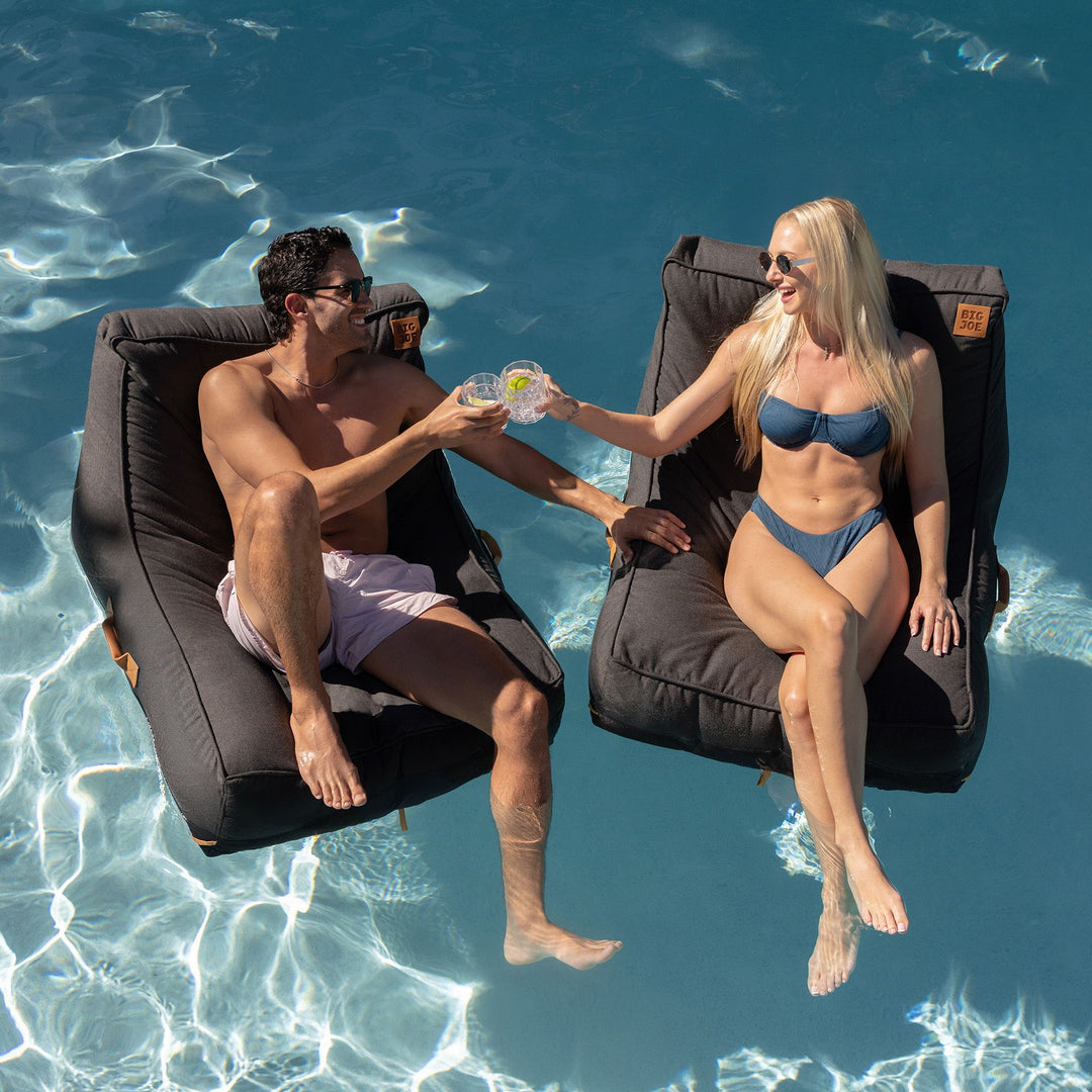 Couple sharing drinks on Lux Sealander Pool Lounger #color_twilight-sunbrella-fabric