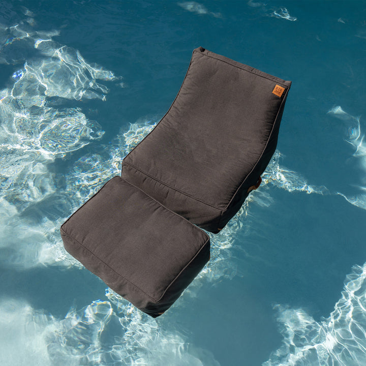 Brown cushion floating in clear blue water #color_twilight-sunbrella-fabric