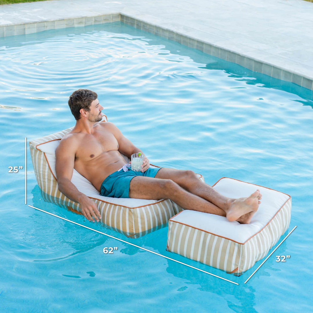 Man lounging on a striped pool float with dimensions displayed, in a pool setting. #color_sand-stripe-sunbrella-fabric