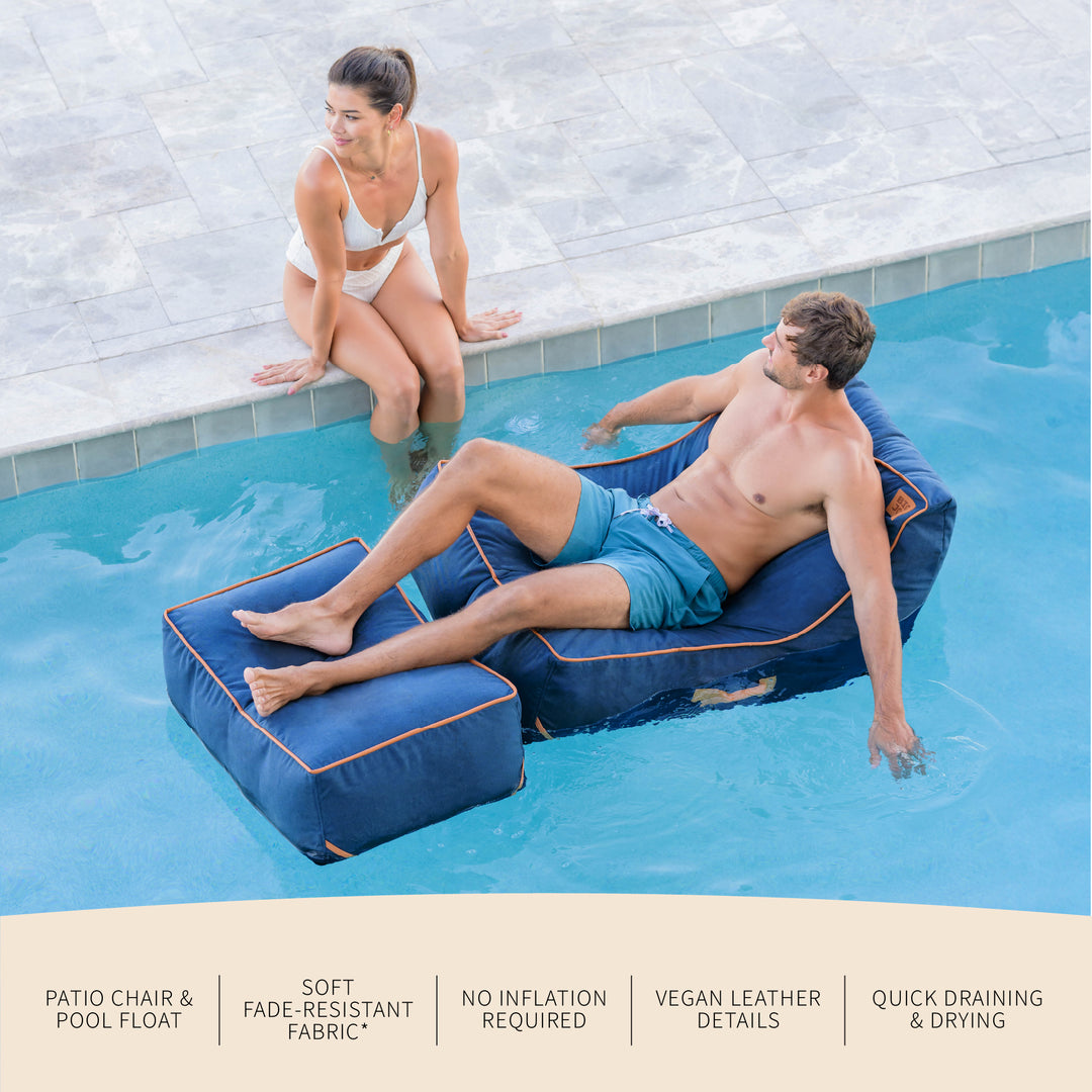 Two people relaxing on pool chairs by a pool. #color_harbor-blue-sunbrella-fabric