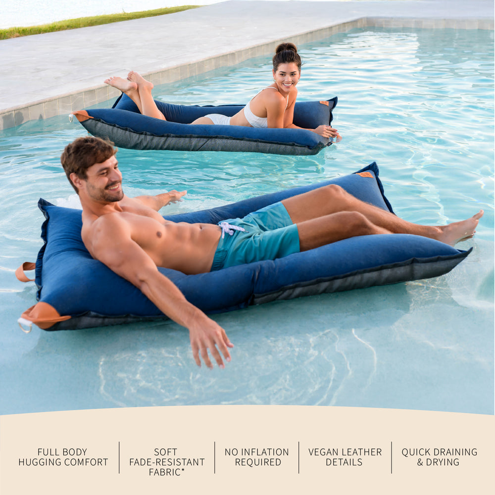 Two people relaxing on inflatable bean bags in a pool with product features listed below. #color_harbor-blue-sunbrella-fabric