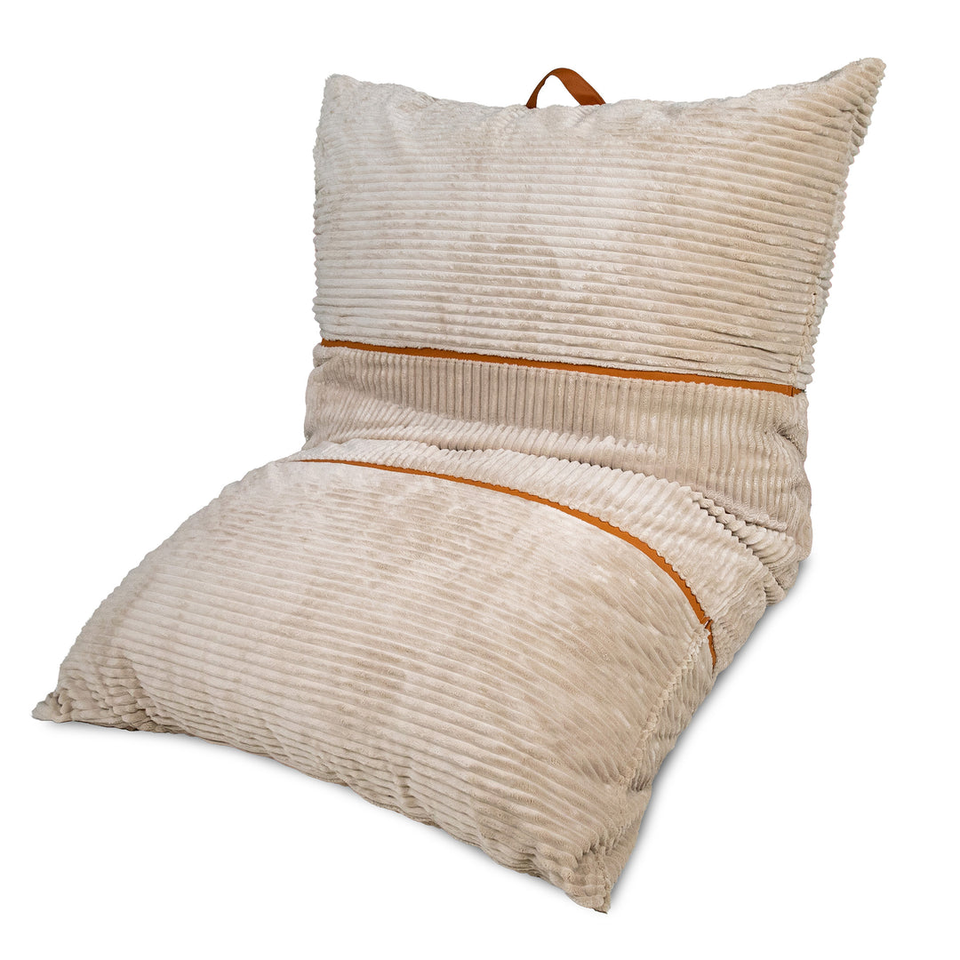 A beige corduroy floor cushion with a matching backrest pillow, featuring a warm brown leather carrying handle and matching brown piping details, shown on a white background. 