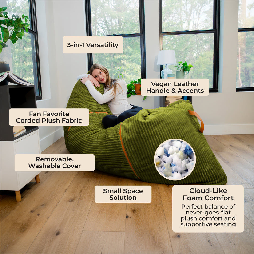 An olive green corduroy bean bag chair with a woman lying on it in a bright room, surrounded by text callouts describing product features and a circular inset showing the plush material. 