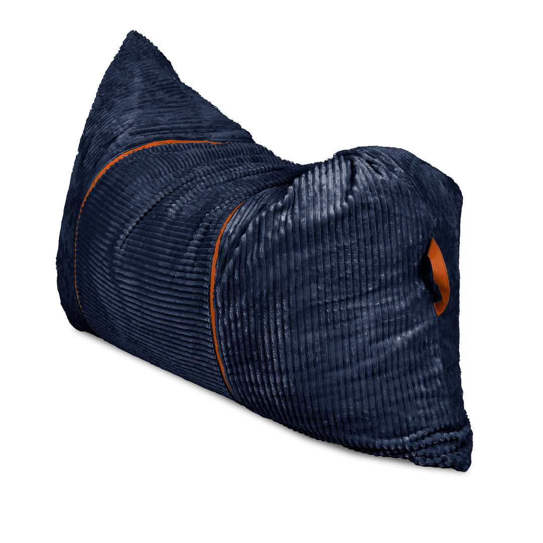 A dark navy blue corduroy lumbar pillow with orange piping and a matching orange accent tab, shown on a plain white background. 