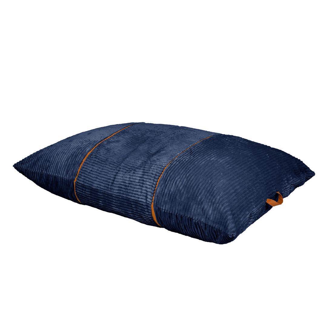 A navy blue textured floor cushion with a ribbed corduroy-like pattern and thin orange-brown piping details, shown on a plain white background. 